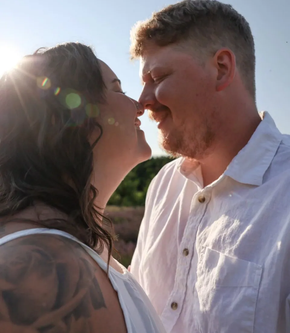 A couple nose to nose in the late sun
